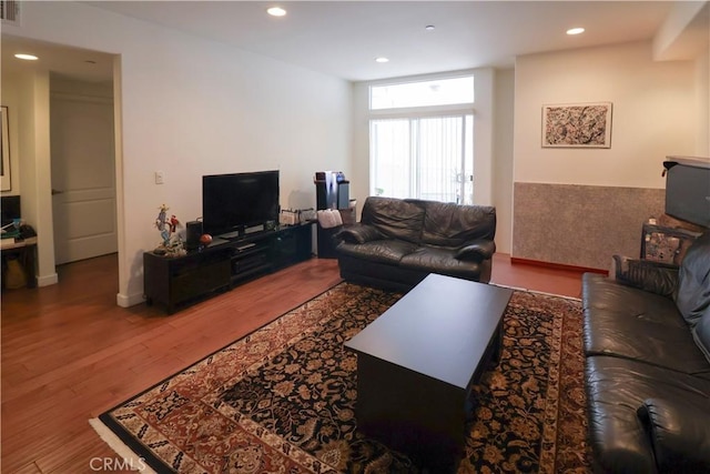 living area featuring recessed lighting, visible vents, and wood finished floors
