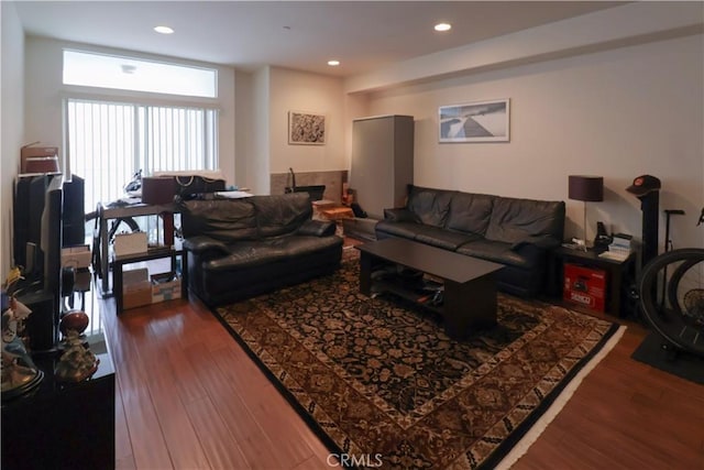 living room featuring recessed lighting and dark wood-style flooring