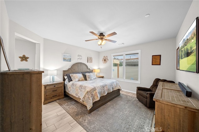 bedroom with visible vents, a ceiling fan, and light wood-style flooring