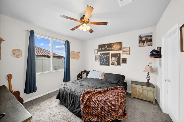 bedroom featuring carpet, ceiling fan, visible vents, and baseboards