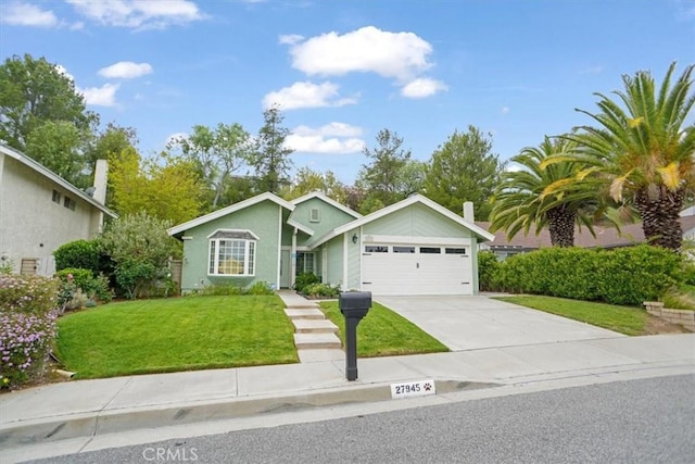 view of front of home with driveway, an attached garage, and a front yard