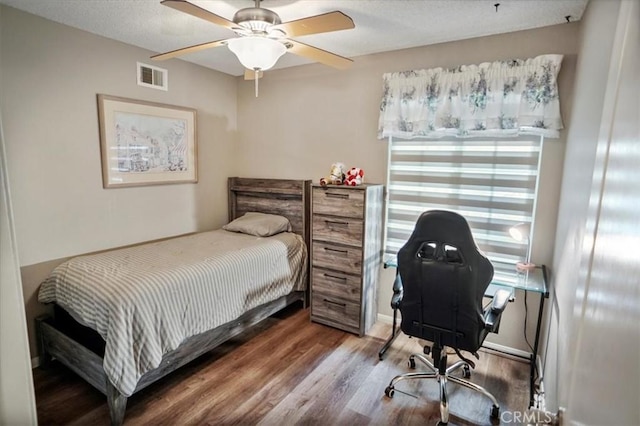 bedroom featuring visible vents, wood finished floors, and ceiling fan
