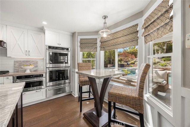 5005 Stonehaven Dr, Yorba Linda, CA 92887 - kitchen featuring decorative backsplash, a warming drawer, light countertops, appliances with stainless steel finishes, and dark wood finished floors