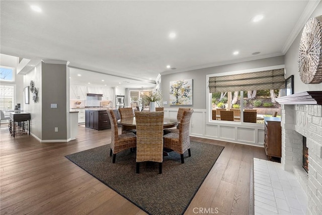 5005 Stonehaven Dr, Yorba Linda, CA 92887 - dining room featuring a brick fireplace, crown molding, dark wood-style flooring, and plenty of natural light