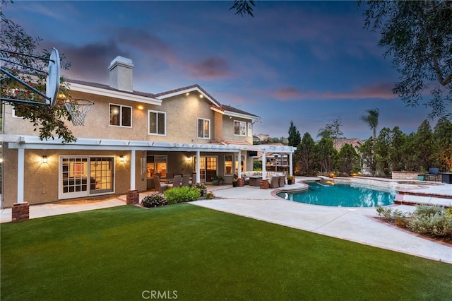 5005 Stonehaven Dr, Yorba Linda, CA 92887 - back of property at dusk featuring an outdoor living space, a lawn, an outdoor pool, a chimney, and stucco siding