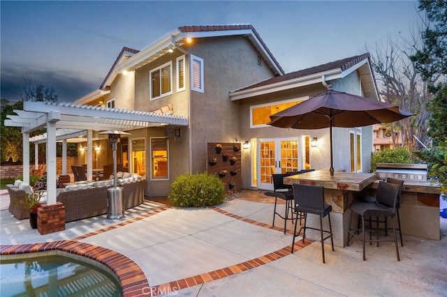 5005 Stonehaven Dr, Yorba Linda, CA 92887 - back of property with stucco siding, a patio, outdoor dry bar, outdoor lounge area, and a pergola