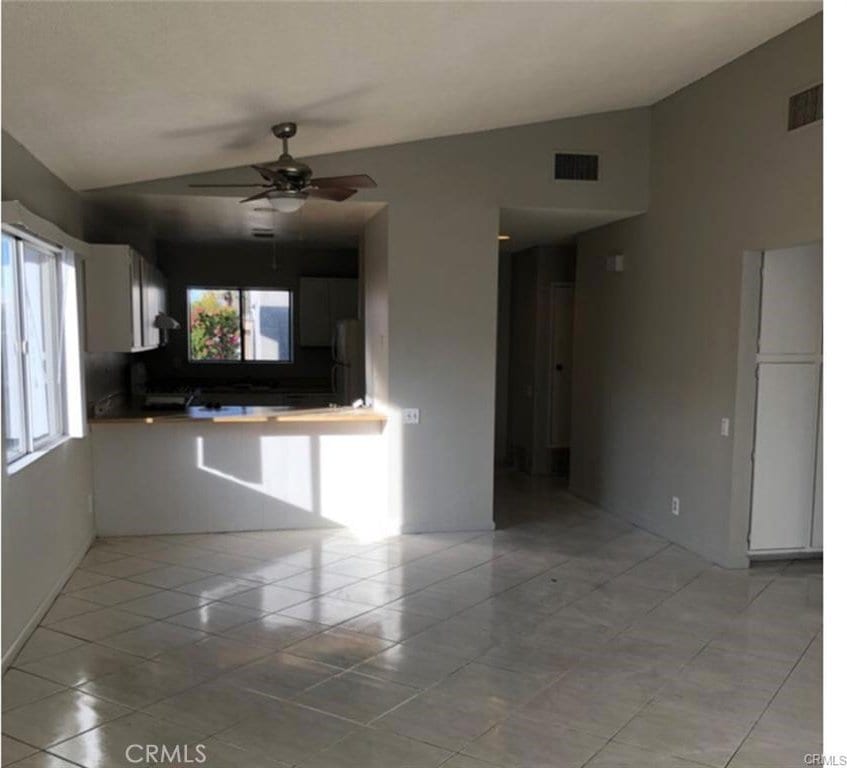 73605 Catalina Way, Palm Desert, CA 92260 - interior space with visible vents, a ceiling fan, vaulted ceiling, and refrigerator