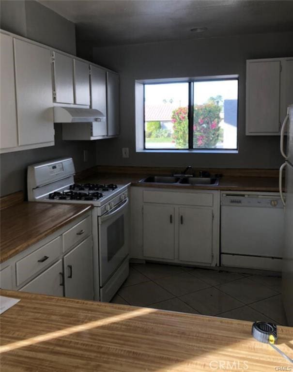 73605 Catalina Way, Palm Desert, CA 92260 - kitchen with white cabinets, a sink, white appliances, light tile patterned floors, and under cabinet range hood