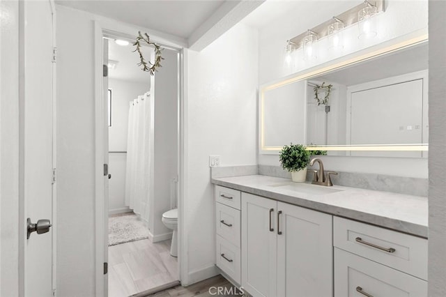 13461 Whittier Ln, Garden Grove, CA 92844 - full bath featuring vanity, wood finished floors, toilet, baseboards, and a shower with shower curtain