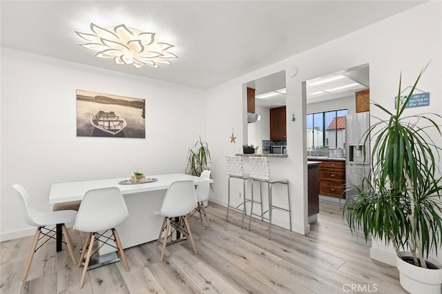 13461 Whittier Ln, Garden Grove, CA 92844 - dining area with baseboards and light wood-style flooring