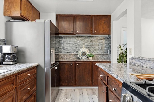13461 Whittier Ln, Garden Grove, CA 92844 - kitchen with stainless steel appliances, light stone countertops, light wood finished floors, and tasteful backsplash