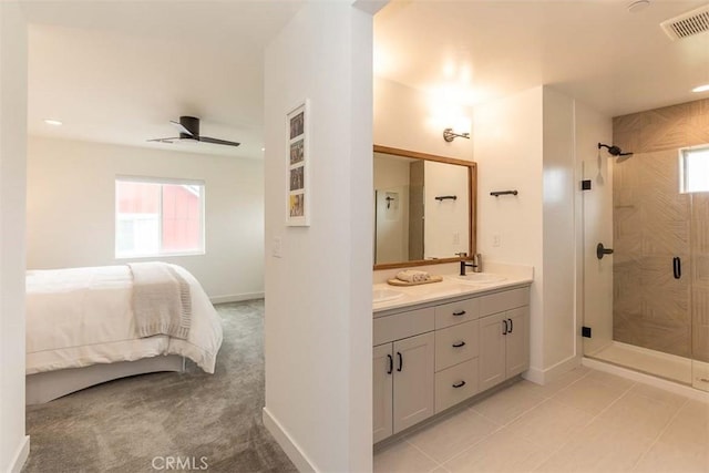 full bathroom featuring a wealth of natural light, a shower stall, connected bathroom, and a sink