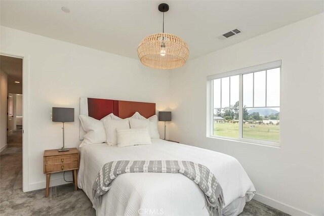 bedroom with visible vents, carpet flooring, and baseboards