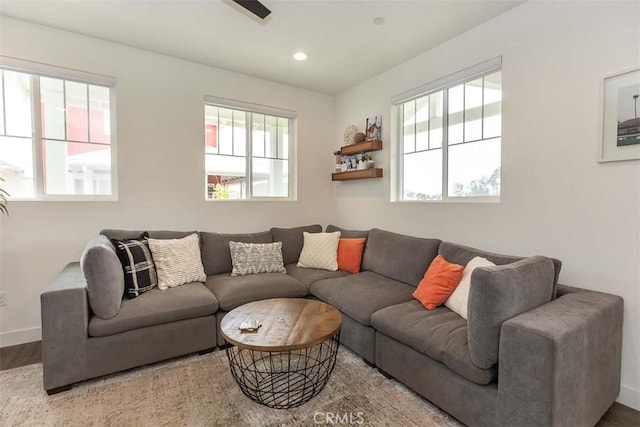 living area featuring baseboards, recessed lighting, and wood finished floors