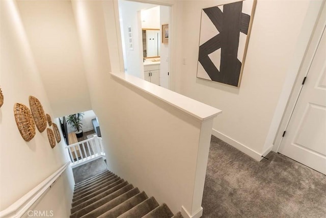 stairs featuring carpet and baseboards