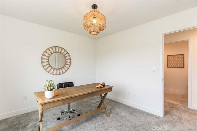 carpeted home office featuring baseboards