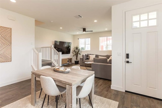 dining room featuring visible vents, wood finished floors, stairs, and recessed lighting