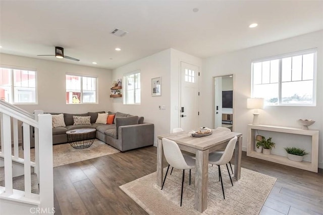 dining area with ceiling fan, visible vents, recessed lighting, wood finished floors, and stairs