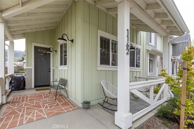entrance to property featuring board and batten siding and a porch