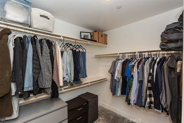 walk in closet with lofted ceiling