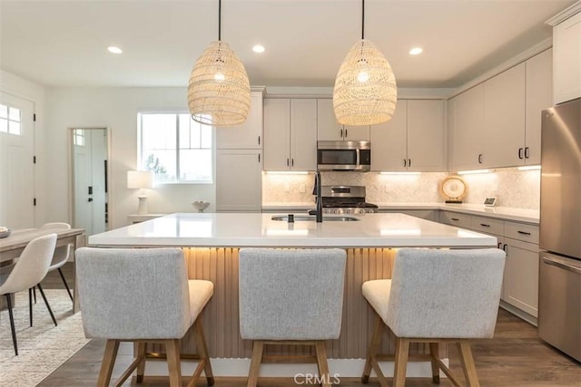 kitchen featuring a sink, appliances with stainless steel finishes, a healthy amount of sunlight, and light countertops
