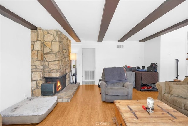 2871 N Wyngate Rd, Orange, CA 92867 - living room featuring visible vents, beam ceiling, a fireplace, and wood finished floors