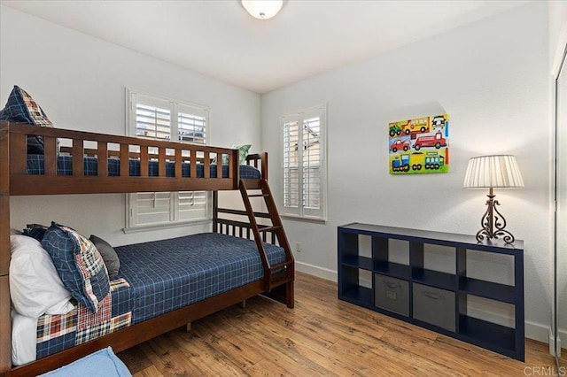 bedroom with wood finished floors and baseboards