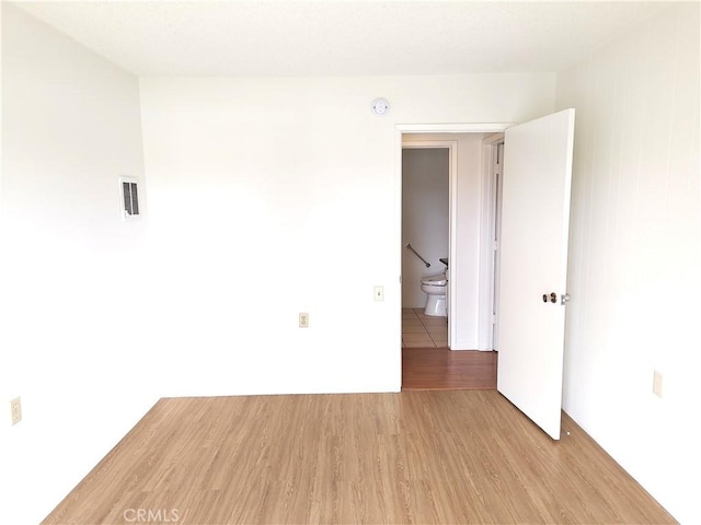 unfurnished room with visible vents and light wood-style flooring