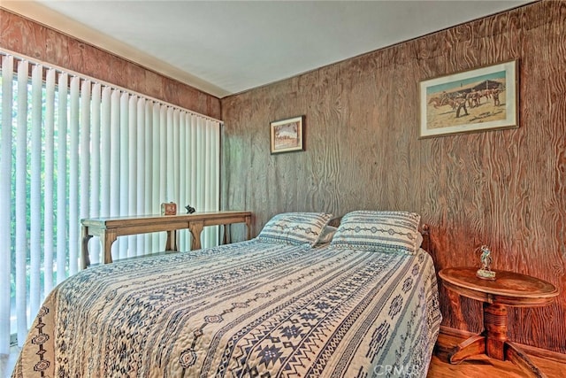 bedroom with wood walls