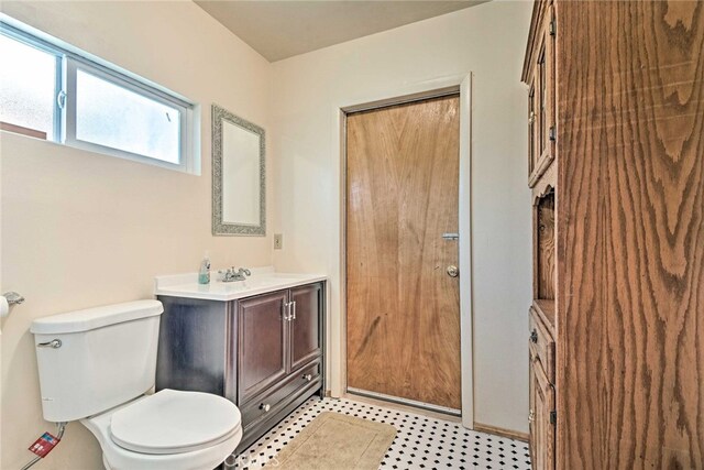 bathroom featuring toilet and vanity