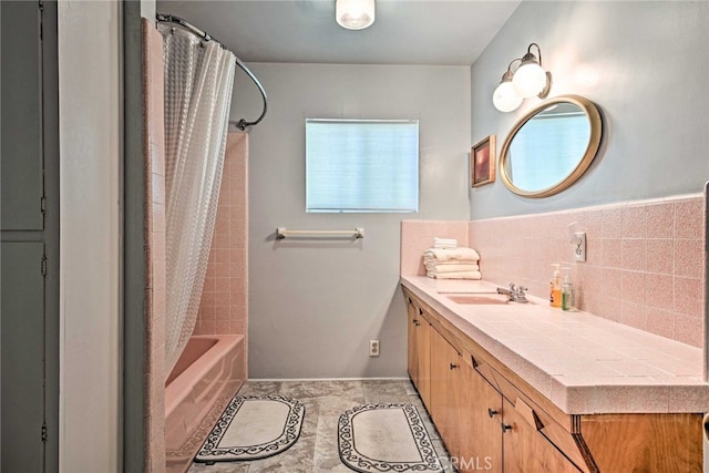full bath with vanity, shower / bath combo with shower curtain, backsplash, baseboards, and tile patterned flooring