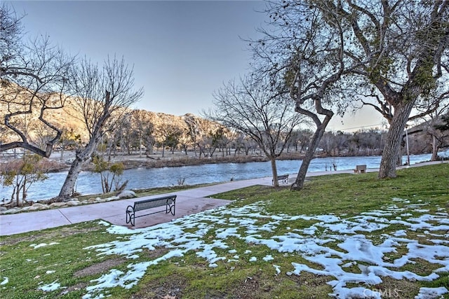 view of community featuring a yard and a water and mountain view