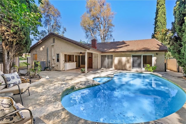 2018 Palisades Dr, Fullerton, CA 92831 - view of swimming pool featuring a pool with connected hot tub, a patio area, a gate, a ceiling fan, and fence