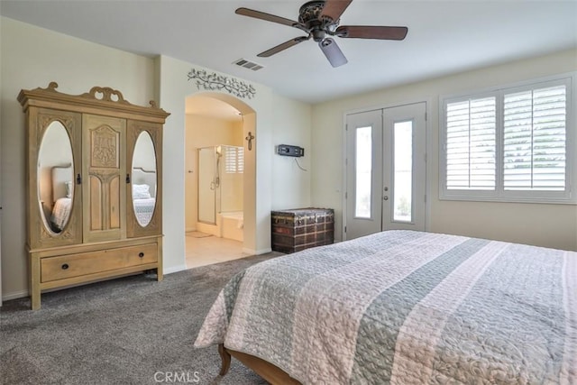 carpeted bedroom featuring access to exterior, visible vents, baseboards, arched walkways, and french doors