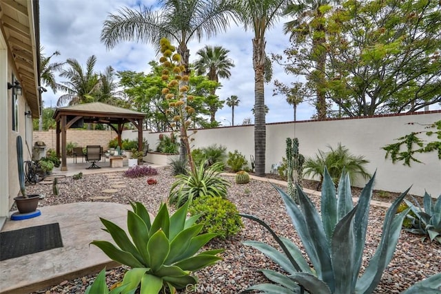 view of yard with a gazebo, a fenced backyard, and a patio area