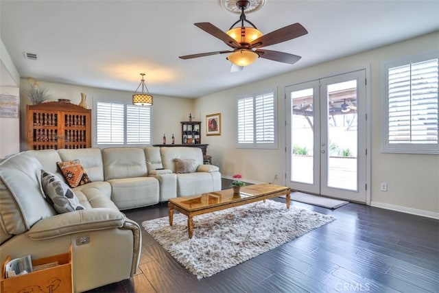 living room with ceiling fan, a wealth of natural light, visible vents, and french doors