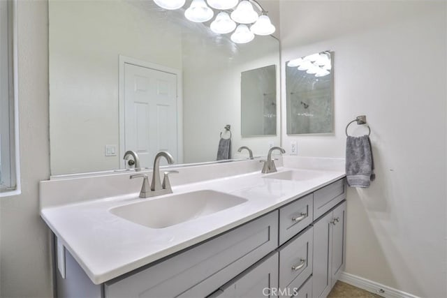 bathroom with double vanity, a sink, and a chandelier
