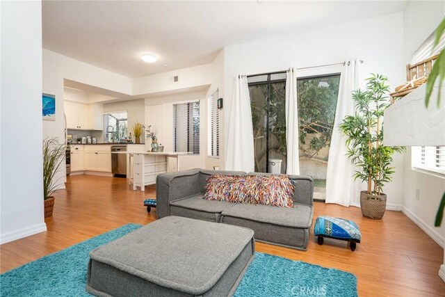 4752 Tiara Dr Unit 103, Huntington Beach, CA 92649 - living room featuring light wood-type flooring and baseboards