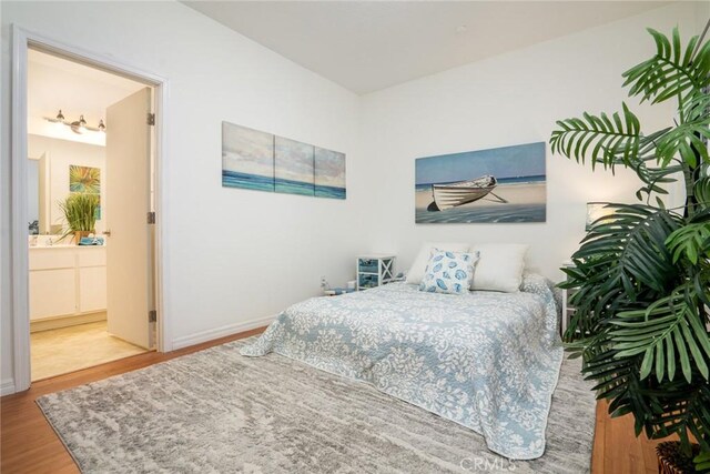 4752 Tiara Dr Unit 103, Huntington Beach, CA 92649 - bedroom featuring wood finished floors, ensuite bathroom, and baseboards
