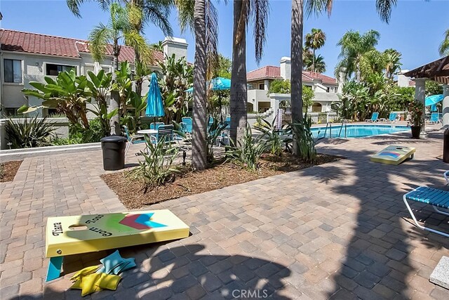 4752 Tiara Dr Unit 103, Huntington Beach, CA 92649 - view of patio / terrace with a community pool