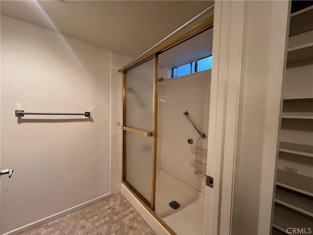 3243 San Amadeo Unit 2H, Laguna Woods, CA 92637 - full bath featuring a shower stall, baseboards, and a walk in closet