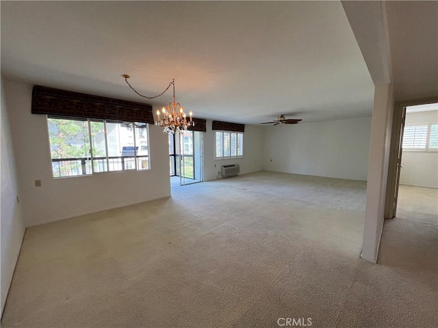 3243 San Amadeo Unit 2H, Laguna Woods, CA 92637 - empty room with ceiling fan with notable chandelier, light carpet, and a wall mounted AC