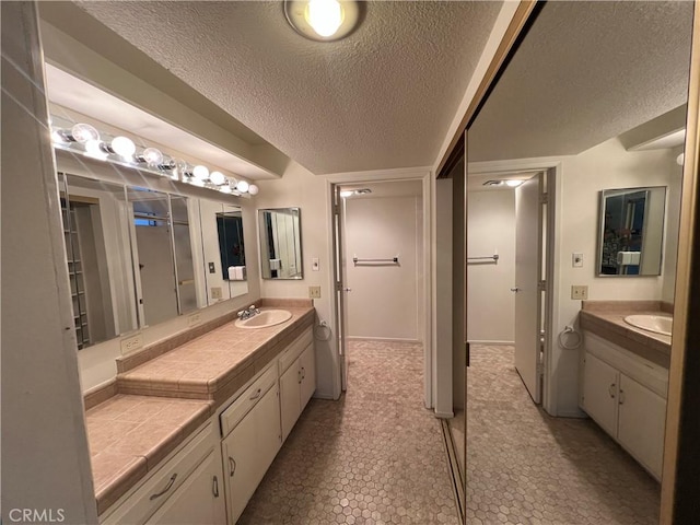 3243 San Amadeo Unit 2H, Laguna Woods, CA 92637 - bathroom with a textured ceiling and vanity