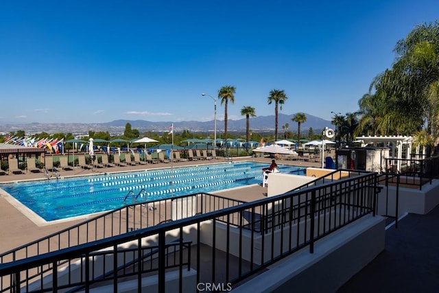 3243 San Amadeo Unit 2H, Laguna Woods, CA 92637 - pool with a mountain view and a patio area