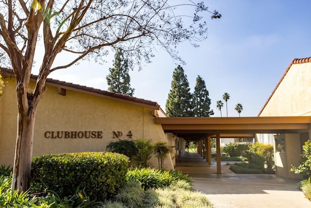 3243 San Amadeo Unit 2H, Laguna Woods, CA 92637 - exterior space featuring a carport and stucco siding