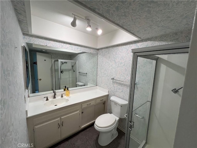 3243 San Amadeo Unit 2H, Laguna Woods, CA 92637 - bathroom with toilet, a stall shower, tile patterned floors, and vanity