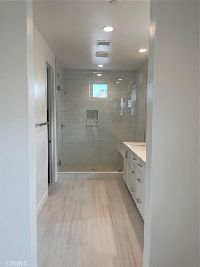 bathroom with visible vents, vanity, recessed lighting, and a stall shower