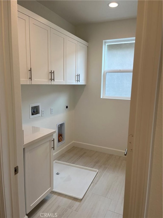 washroom featuring electric dryer hookup, baseboards, hookup for a washing machine, recessed lighting, and cabinet space