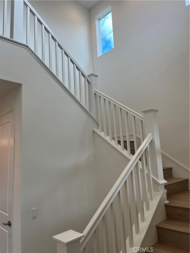 stairs featuring a towering ceiling