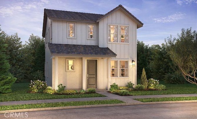 modern farmhouse with roof with shingles and board and batten siding